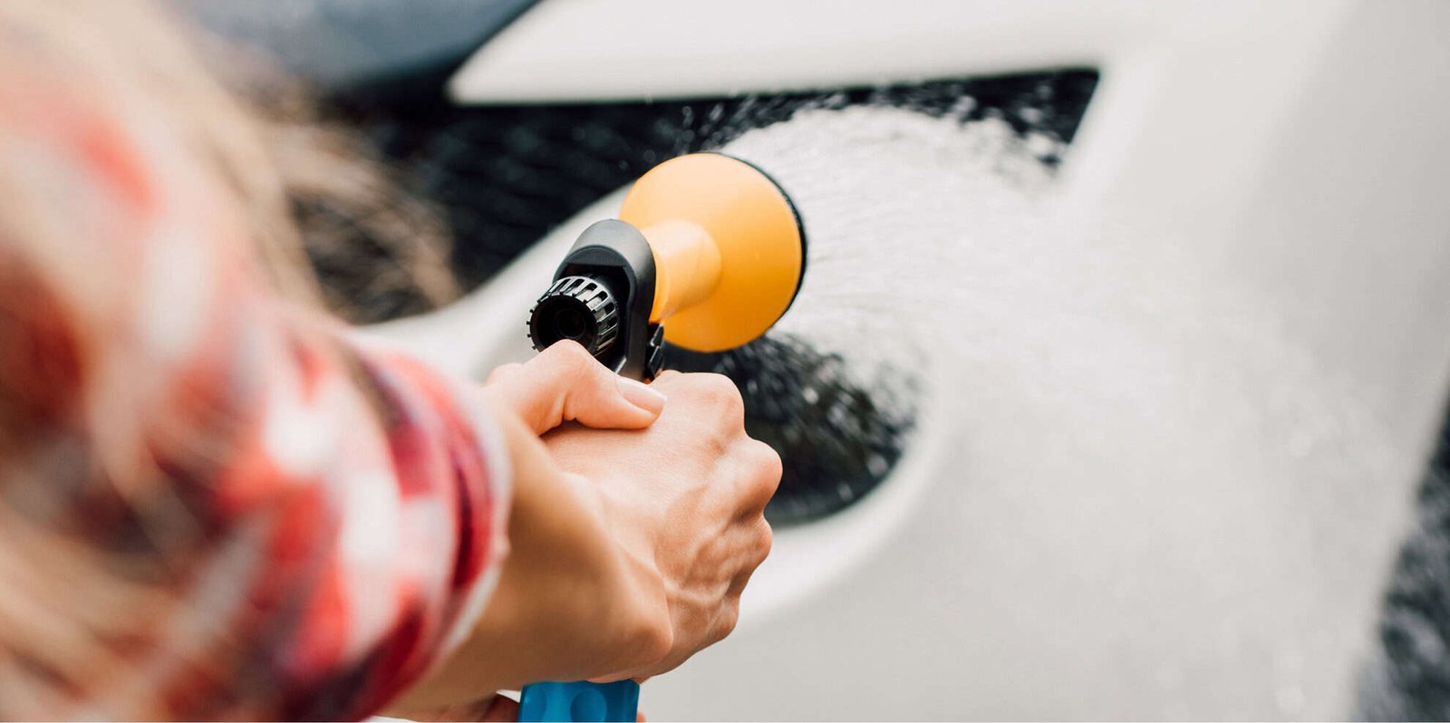 cropped-view-of-woman-washing-car-while-holding-pr-2024-11-09-19-48-53-utc
